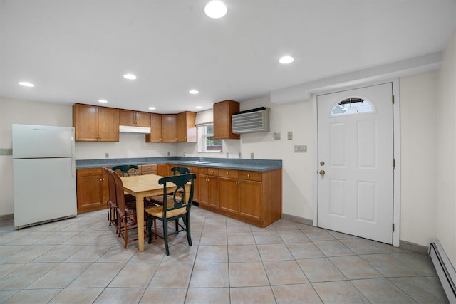 336 Mile Square Rd, Yonkers, NY 10701 - kitchen featuring freestanding refrigerator, baseboard heating, under cabinet range hood, recessed lighting, and dark countertops