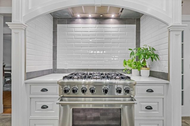 27 Olmsted Rd, Scarsdale, NY 10583 - kitchen featuring high end stove, light countertops, white cabinetry, and decorative backsplash