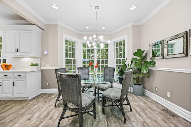 27 Olmsted Rd, Scarsdale, NY 10583 - dining space with light wood-style flooring, a chandelier, baseboards, recessed lighting, and crown molding