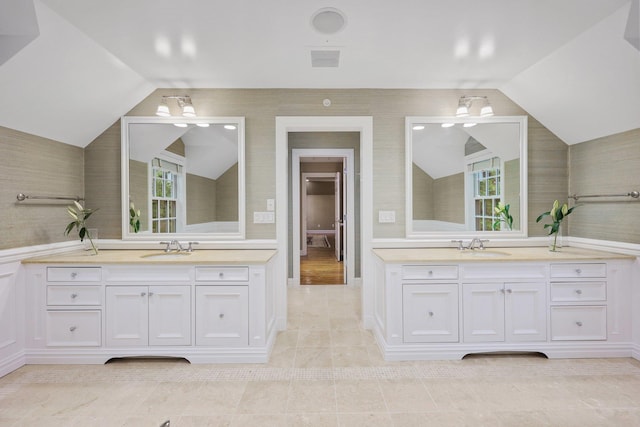 27 Olmsted Rd, Scarsdale, NY 10583 - bathroom featuring vaulted ceiling, two vanities, and plenty of natural light