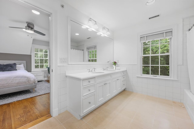 27 Olmsted Rd, Scarsdale, NY 10583 - ensuite bathroom with vanity, tile walls, healthy amount of natural light, a ceiling fan, and tile patterned floors