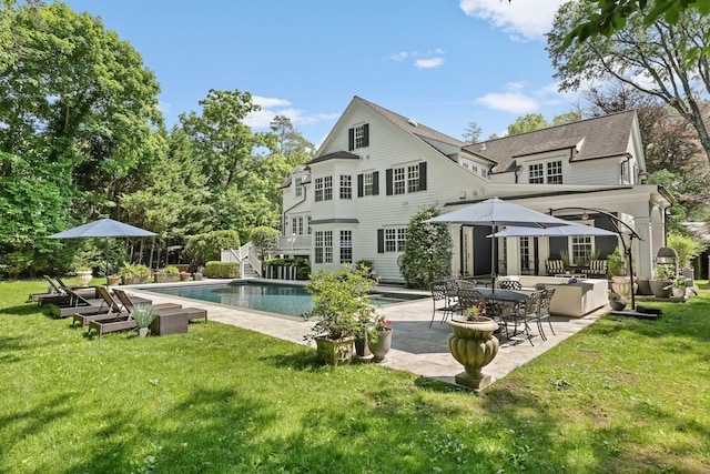 27 Olmsted Rd, Scarsdale, NY 10583 - back of house featuring a patio area, a lawn, and an outdoor pool