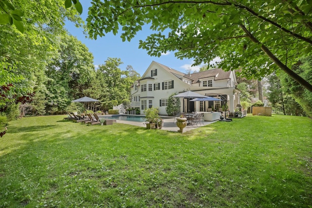 27 Olmsted Rd, Scarsdale, NY 10583 - rear view of property featuring a patio, a lawn, and an outdoor pool