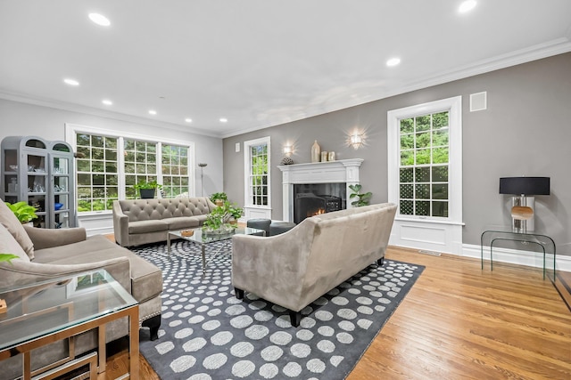 27 Olmsted Rd, Scarsdale, NY 10583 - living area featuring ornamental molding, wood finished floors, a lit fireplace, healthy amount of natural light, and recessed lighting