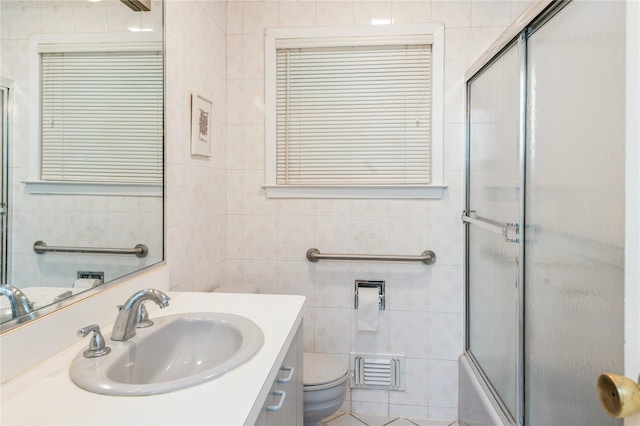 4 Roland Ct, Nanuet, NY 10954 - full bathroom featuring tile walls, vanity, and bath / shower combo with glass door