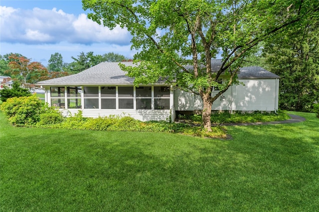 4 Roland Ct, Nanuet, NY 10954 - back of property featuring a sunroom, a shingled roof, and a yard