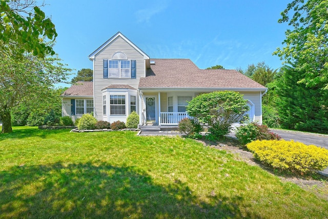 8 Thunder Rd, Miller Place, NY 11764 - traditional-style house featuring covered porch, a front yard, and asphalt driveway