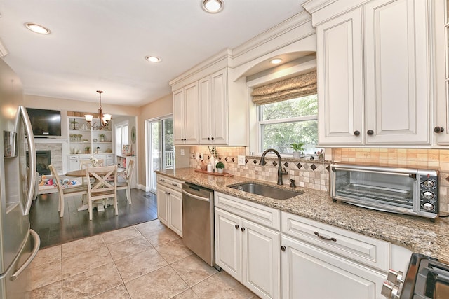8 Thunder Rd, Miller Place, NY 11764 - kitchen with stainless steel appliances, a sink, healthy amount of natural light, recessed lighting, and tasteful backsplash