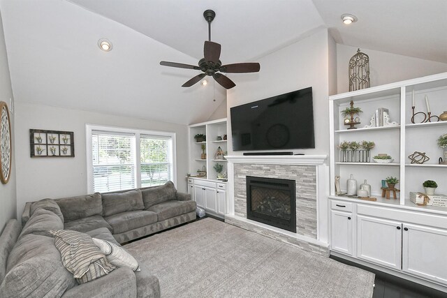 8 Thunder Rd, Miller Place, NY 11764 - living area with vaulted ceiling, a ceiling fan, a tile fireplace, and built in shelves