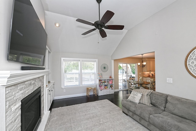 8 Thunder Rd, Miller Place, NY 11764 - living room featuring dark wood-style flooring, a ceiling fan, a fireplace, a chandelier, and high vaulted ceiling