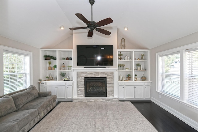 8 Thunder Rd, Miller Place, NY 11764 - living area with vaulted ceiling, a ceiling fan, plenty of natural light, a tiled fireplace, and dark wood finished floors