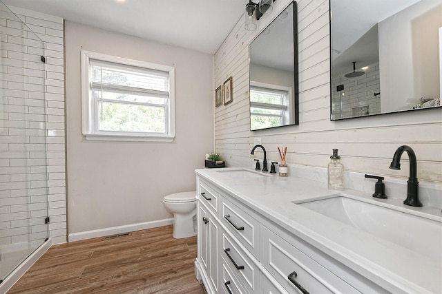 8 Thunder Rd, Miller Place, NY 11764 - bathroom featuring a tile shower, double vanity, toilet, wood finished floors, and baseboards