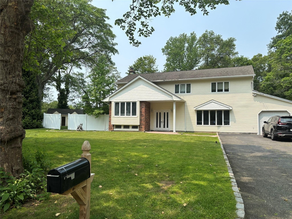 6 Attridge Ct, Melville, NY 11747 - view of front of house with french doors, driveway, and a garage