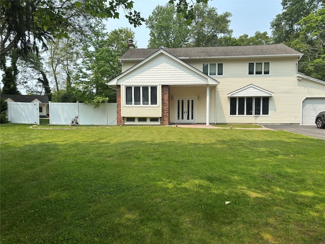6 Attridge Ct, Melville, NY 11747 - view of front facade featuring french doors, a garage, a chimney, and asphalt driveway
