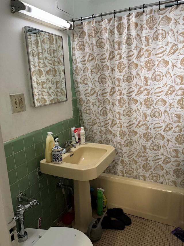 1920 S Mcgraw Ave S Unit 7D, Bronx, NY 10462 - full bath featuring tile walls, shower / bath combo, tile patterned floors, a wainscoted wall, and toilet