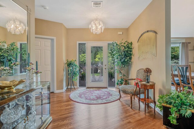 6 Ring Neck Ct, Wading River, NY 11792 - foyer featuring a chandelier and wood finished floors