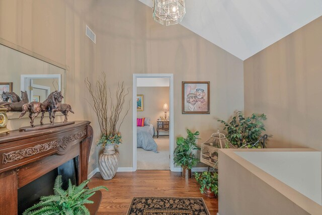 6 Ring Neck Ct, Wading River, NY 11792 - foyer entrance featuring high vaulted ceiling, wood finished floors, and a chandelier
