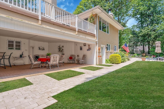 6 Ring Neck Ct, Wading River, NY 11792 - rear view of house with a patio, a lawn, a chimney, a balcony, and outdoor dining area