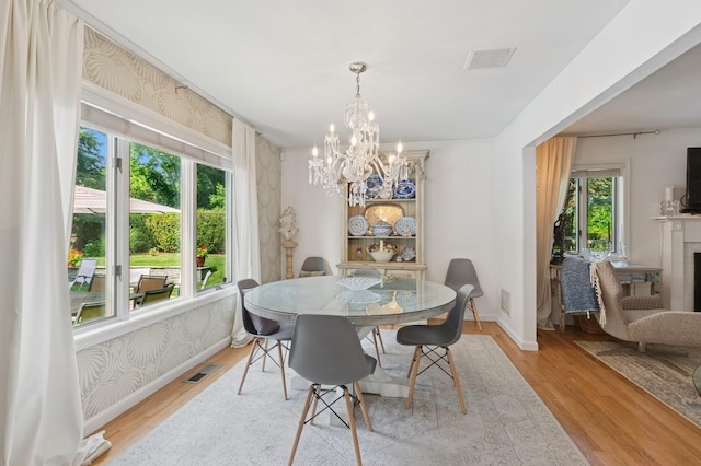 26405 Main Rd, Cutchogue, NY 11935 - dining room featuring light wood-type flooring and a chandelier