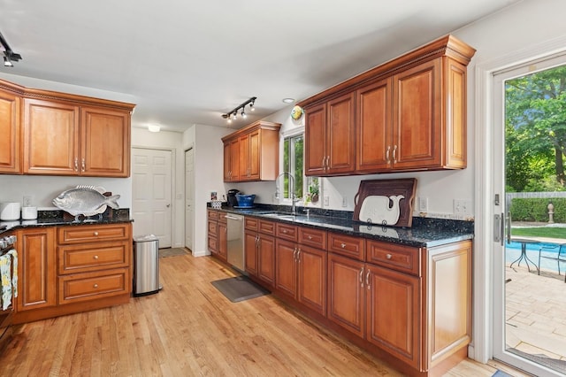 26405 Main Rd, Cutchogue, NY 11935 - kitchen featuring stainless steel dishwasher, track lighting, light wood-type flooring, and brown cabinetry