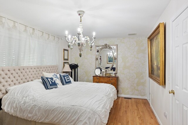 26405 Main Rd, Cutchogue, NY 11935 - bedroom featuring wallpapered walls, a chandelier, and wood finished floors