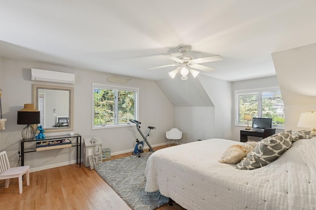 26405 Main Rd, Cutchogue, NY 11935 - bedroom with an AC wall unit, wood finished floors, multiple windows, and a ceiling fan