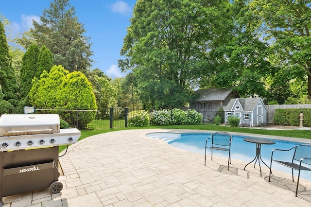26405 Main Rd, Cutchogue, NY 11935 - view of swimming pool with grilling area, a patio, a shed, and view of wooded area