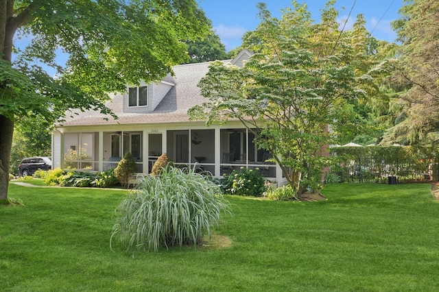 26405 Main Rd, Cutchogue, NY 11935 - back of property featuring a sunroom, a yard, a ceiling fan, and roof with shingles