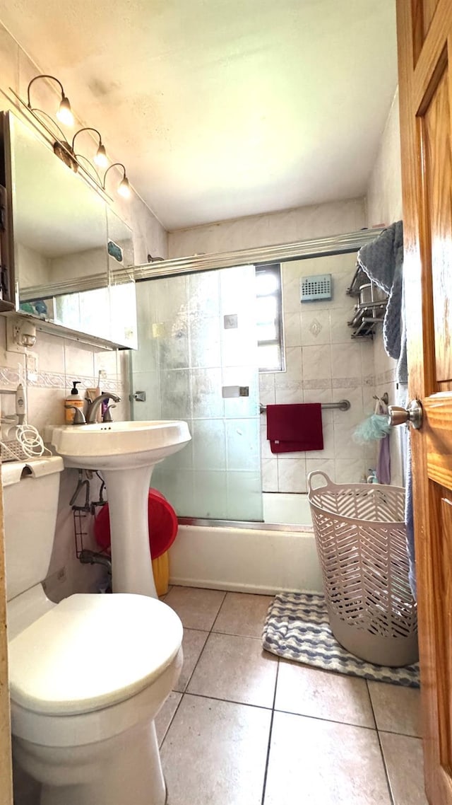 31-50 140th St Unit 1L, Flushing, NY 11354 - bathroom featuring tile patterned flooring, combined bath / shower with glass door, and toilet