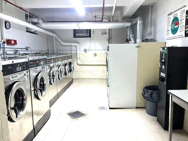 31-50 140th St Unit 1L, Flushing, NY 11354 - shared laundry room featuring concrete block wall and independent washer and dryer