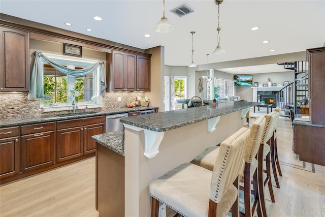 226 Windsor Rd, Fishkill, NY 12524 - kitchen featuring dishwasher, light wood-style floors, a kitchen bar, tasteful backsplash, and recessed lighting