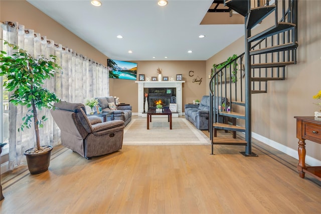 226 Windsor Rd, Fishkill, NY 12524 - living room with wood finished floors, recessed lighting, a warm lit fireplace, and stairway