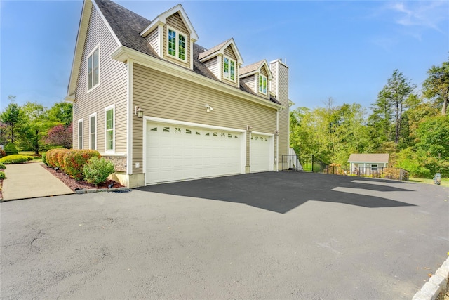 226 Windsor Rd, Fishkill, NY 12524 - view of side of property with driveway, an attached garage, and a chimney