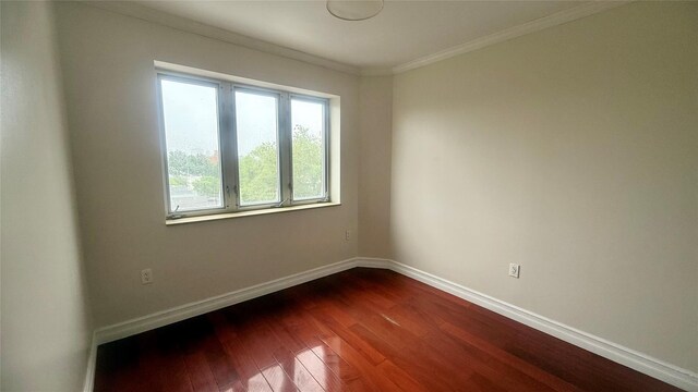 8510 Elmhurst Ave Unit 6B, Elmhurst, NY 11373 - unfurnished room with dark wood-style floors, crown molding, and baseboards