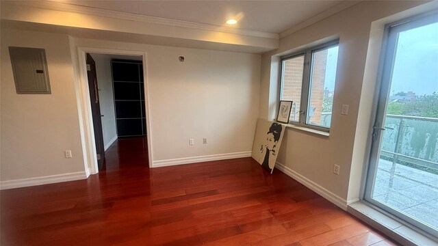 8510 Elmhurst Ave Unit 6B, Elmhurst, NY 11373 - unfurnished room featuring electric panel, ornamental molding, wood finished floors, plenty of natural light, and baseboards