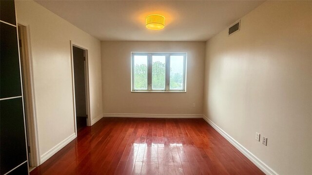 8510 Elmhurst Ave Unit 6B, Elmhurst, NY 11373 - unfurnished bedroom featuring hardwood / wood-style floors and baseboards