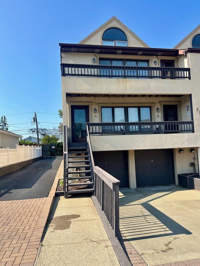 639 E Broadway Unit 5, Long Beach, NY 11561 - view of property with stairway, driveway, and a garage