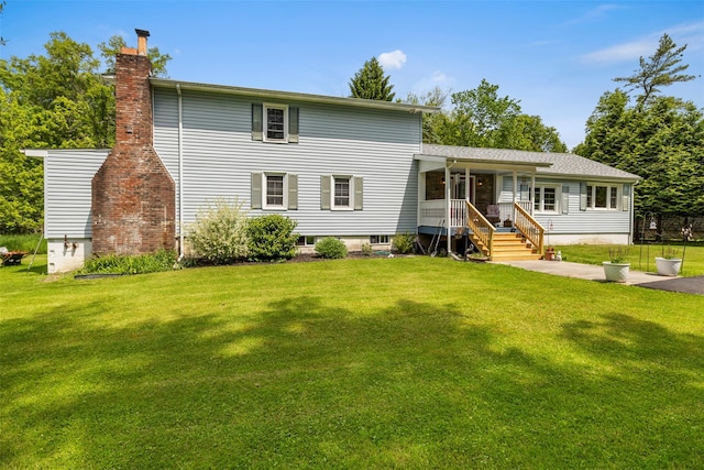 2410 Bruynswick Rd, Wallkill, NY 12589 - view of front of property featuring a front yard, a chimney, and a porch