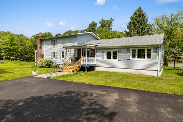 2410 Bruynswick Rd, Wallkill, NY 12589 - view of front of home with a front yard, covered porch, a chimney, and roof with shingles
