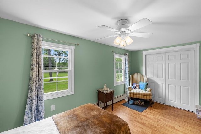 2410 Bruynswick Rd, Wallkill, NY 12589 - bedroom featuring a baseboard heating unit, light wood-type flooring, a closet, and ceiling fan