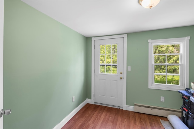 2410 Bruynswick Rd, Wallkill, NY 12589 - doorway with a baseboard heating unit, wood finished floors, baseboards, and plenty of natural light