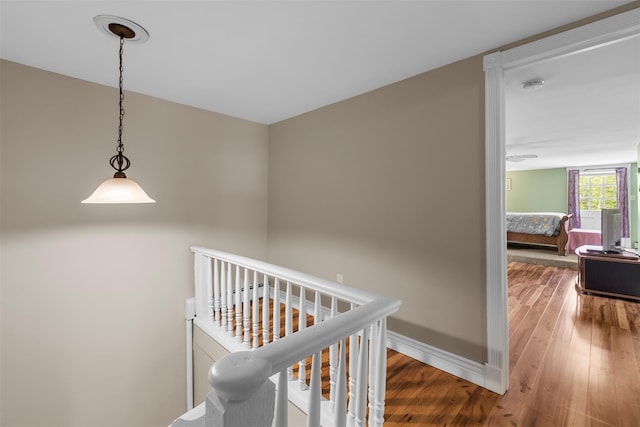 2410 Bruynswick Rd, Wallkill, NY 12589 - corridor featuring wood finished floors, baseboards, and an upstairs landing