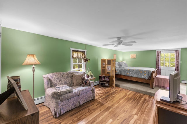 2410 Bruynswick Rd, Wallkill, NY 12589 - bedroom with a baseboard radiator, wood finished floors, and ceiling fan