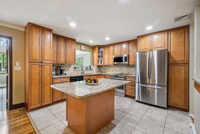 26 Crown Hill Rd, Wappingers Falls, NY 12590 - kitchen with stainless steel appliances, brown cabinetry, decorative backsplash, healthy amount of natural light, and recessed lighting