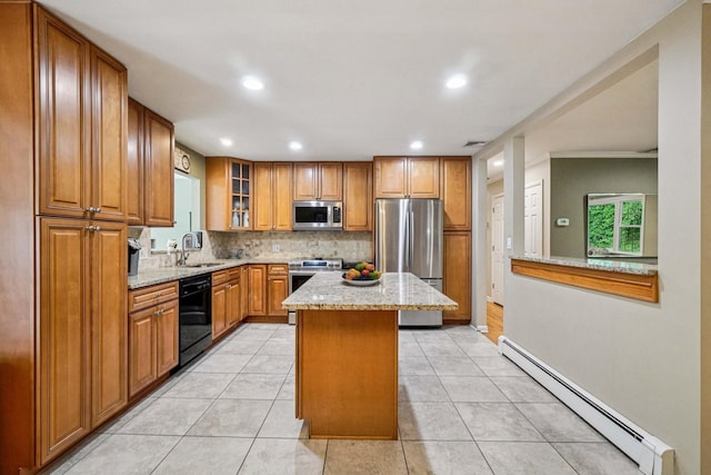 26 Crown Hill Rd, Wappingers Falls, NY 12590 - kitchen featuring stainless steel appliances, a baseboard radiator, brown cabinetry, decorative backsplash, and light stone countertops