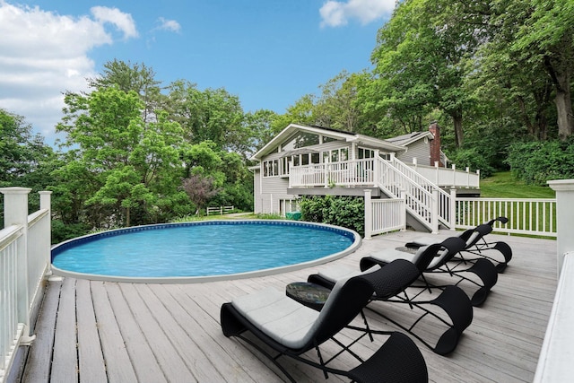 26 Crown Hill Rd, Wappingers Falls, NY 12590 - swimming pool with a deck, stairs, a sunroom, and view of scattered trees