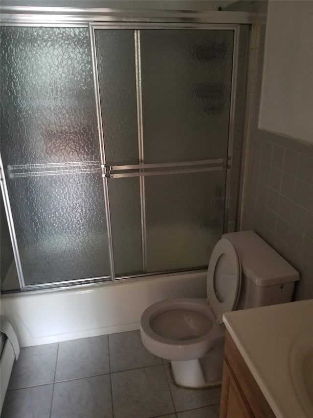 134-46 Maple Ave Unit 1C, Flushing, NY 11355 - full bath featuring vanity, tile walls, tile patterned flooring, and shower / bath combination with glass door