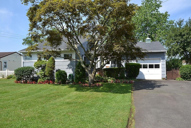 1318 Brooklyn Blvd, Bay Shore, NY 11706 - obstructed view of property featuring driveway, a garage, and a shingled roof