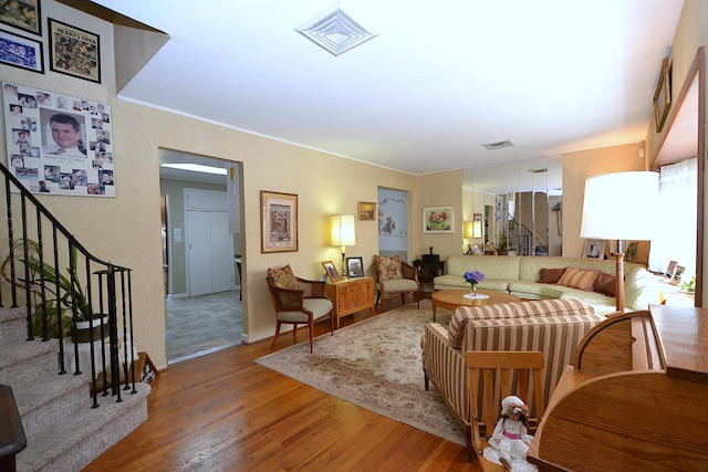 1318 Brooklyn Blvd, Bay Shore, NY 11706 - living room featuring wood finished floors, stairs, and crown molding