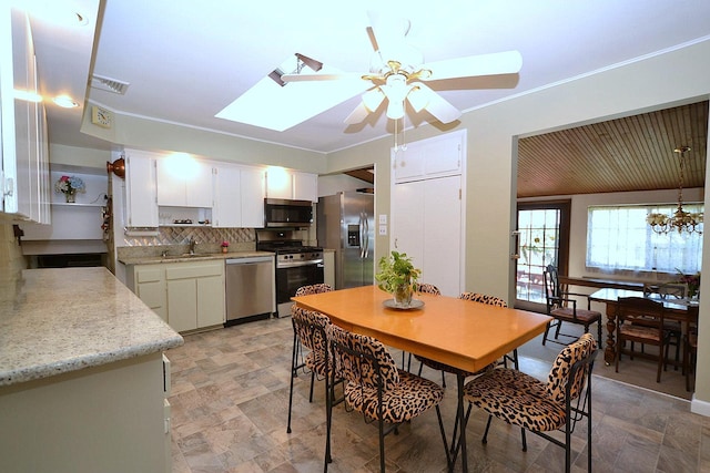 1318 Brooklyn Blvd, Bay Shore, NY 11706 - dining room with a ceiling fan, a skylight, and crown molding